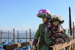 couple in carnival costume on background gondolas